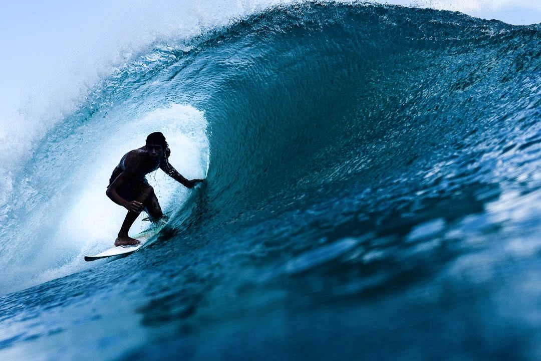 A Surfer riding a barrel wave in Bali
