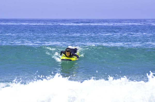 Girl paddling on a surfboard