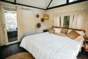 A cosy room with rustic interiors - a room at Rapture Surfcamps, Padang Padang
