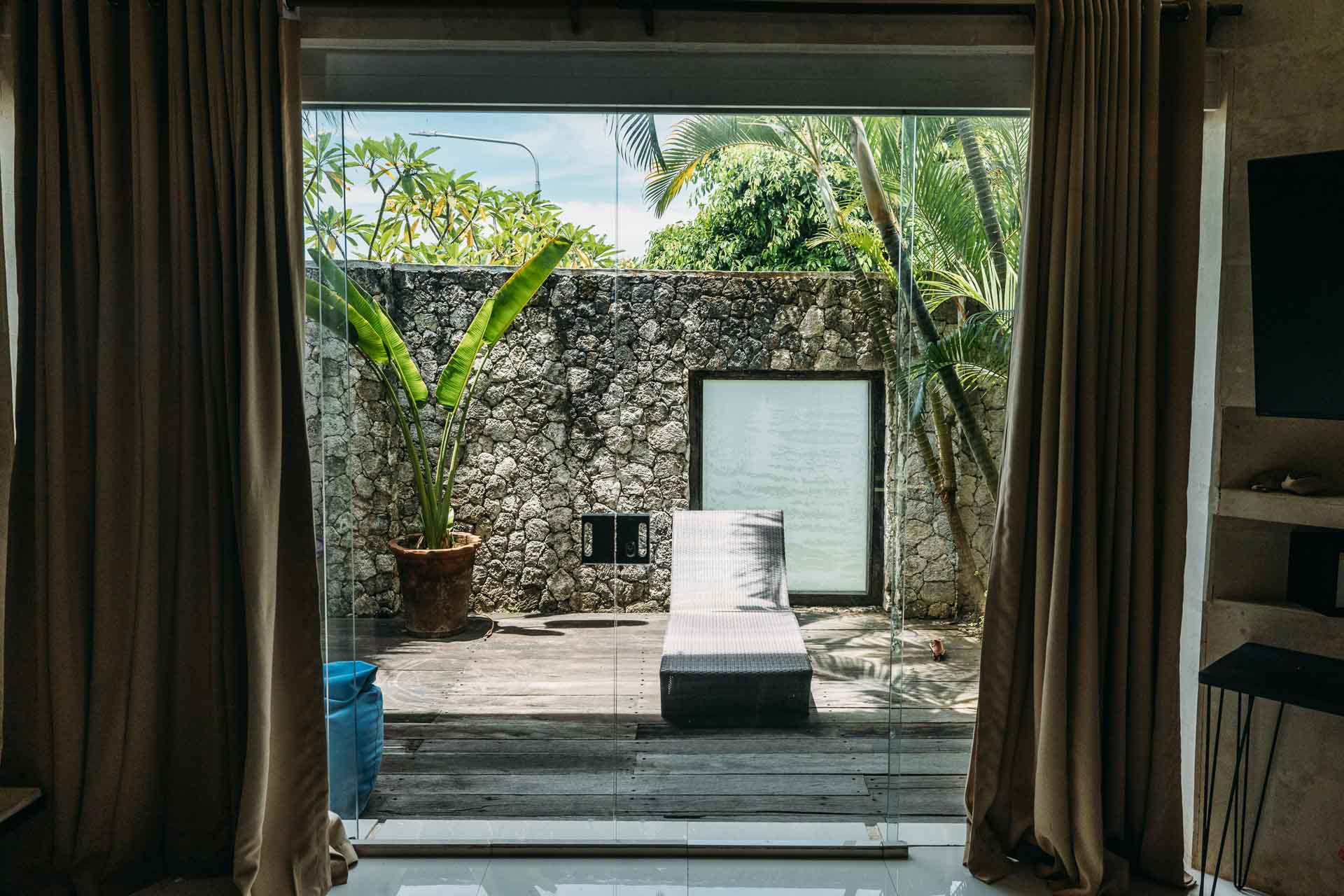 A window showing off a sun terrace in surfcamp private room