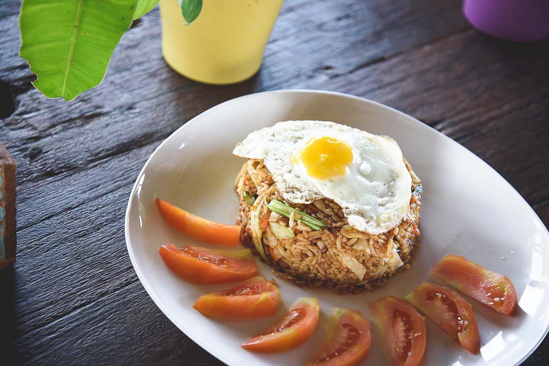 A dish with nasi goreng special and tomato