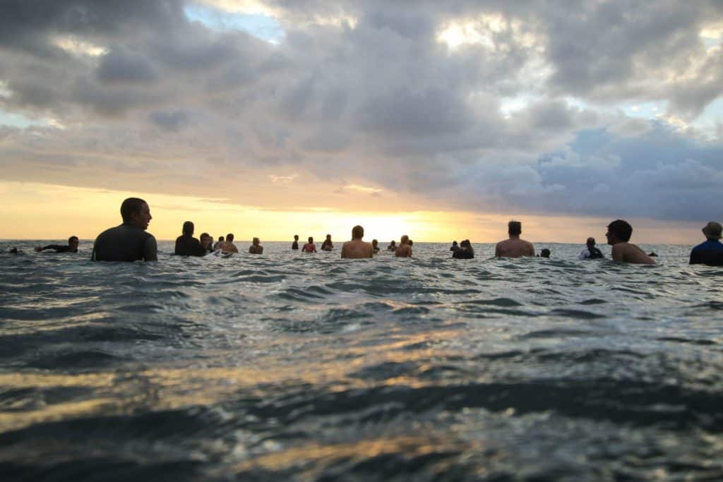 Group of surfers sitting together in the lineup