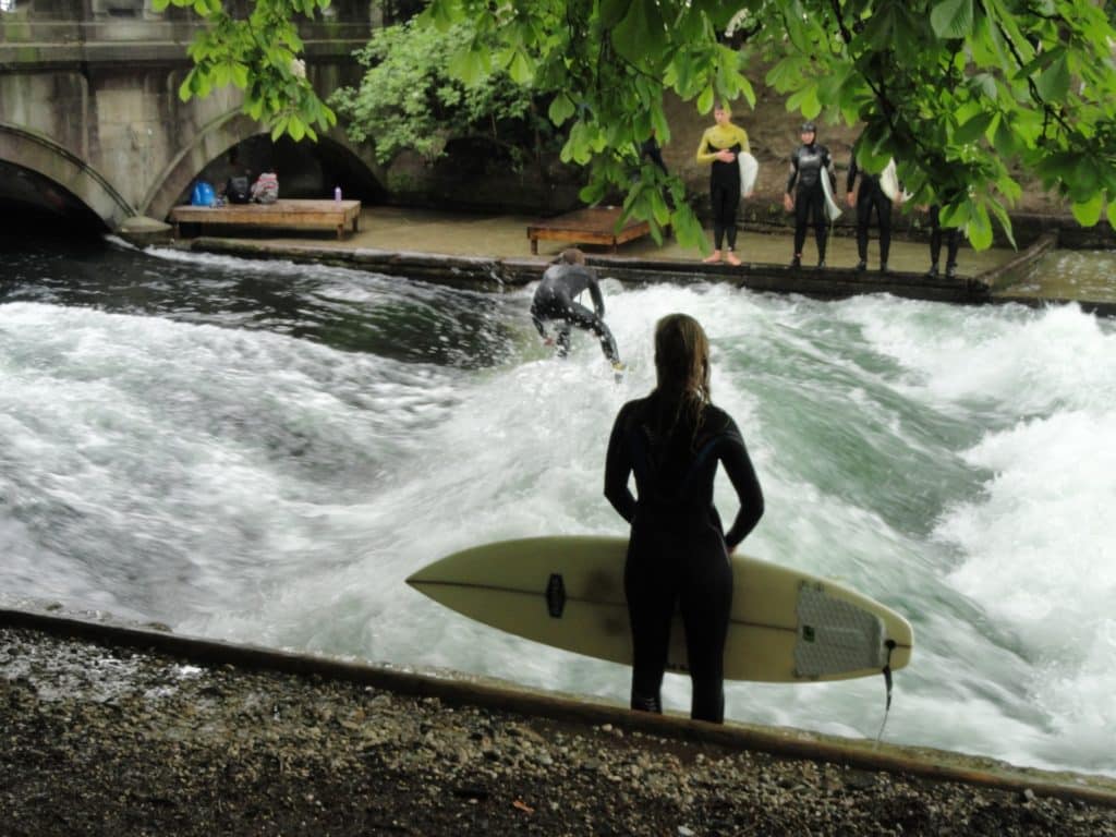Surfers waiting for a turn on the Eisbach. One of Germany and the world's weirdest waves