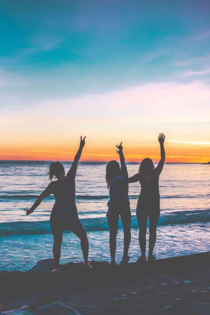Girls watching a sunset over the ocean