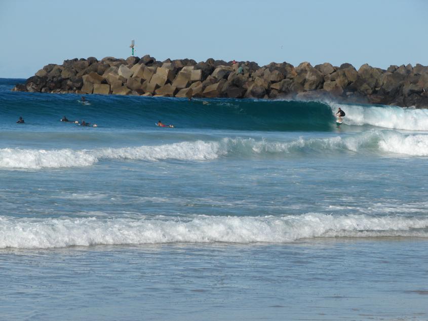 Riding a wave at Duranbah beach in Australia