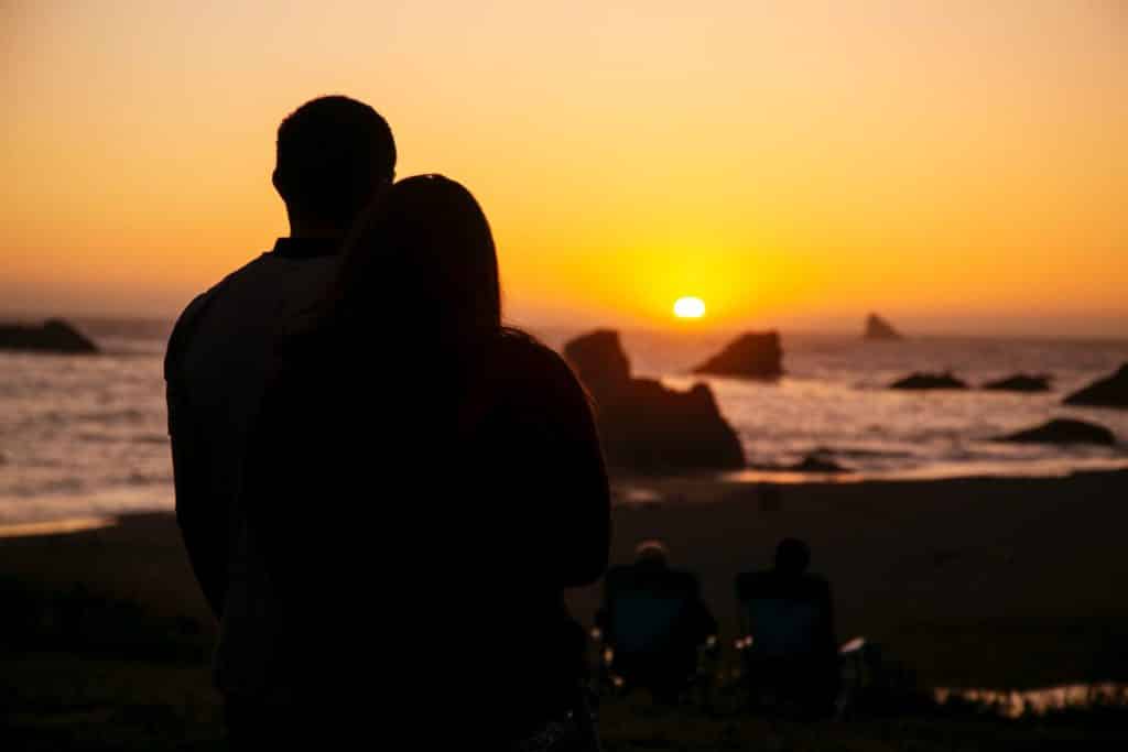 Couple watching sunset at Foz do Lizandro
