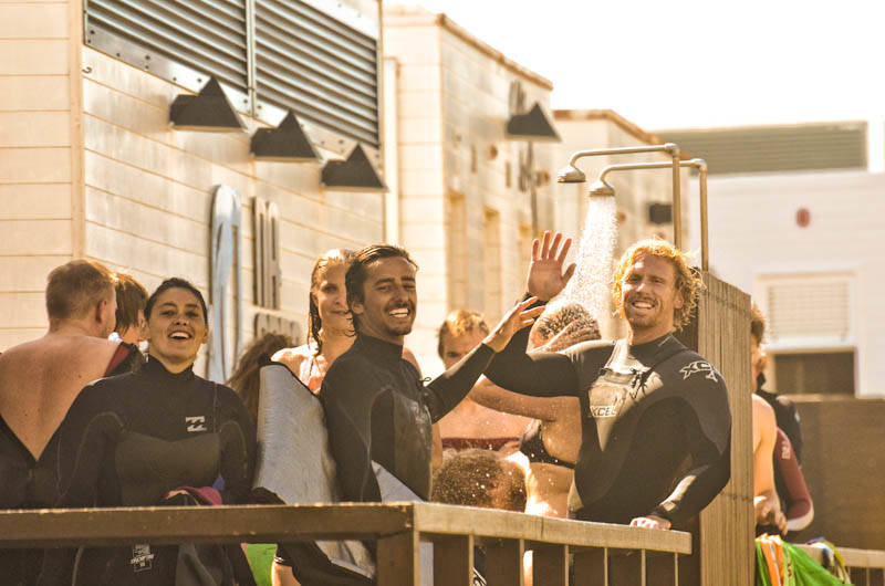 Surfers rinsing off after a surf