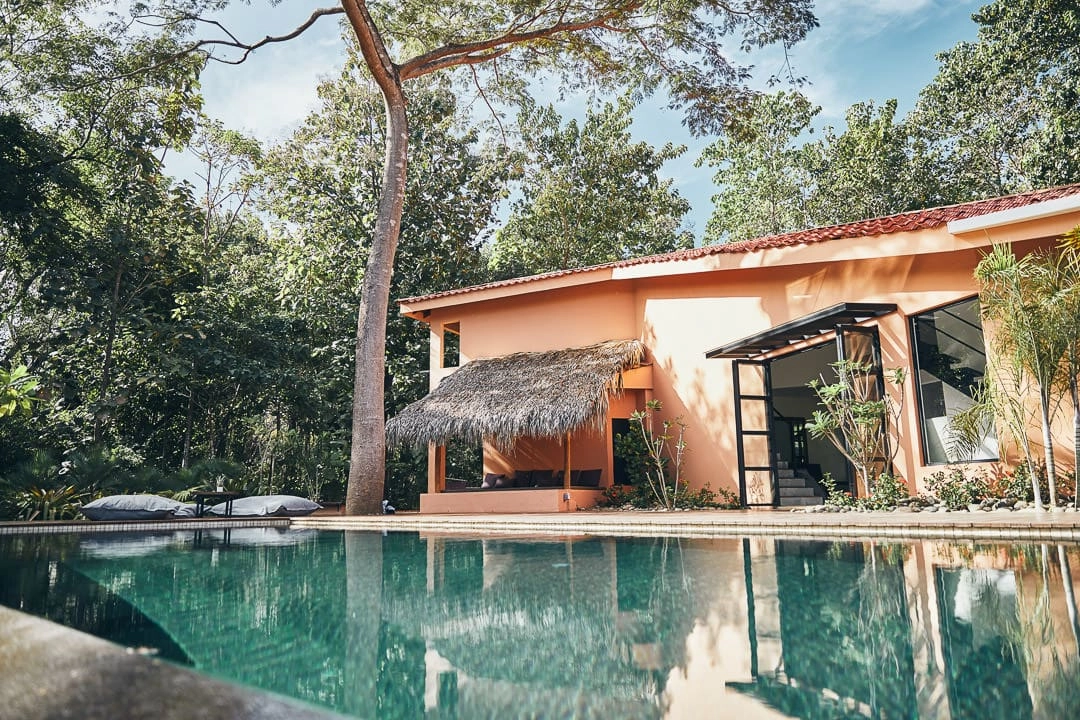 Orange building with pool and jungle