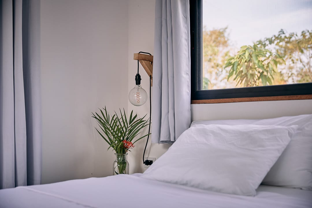 A bed in comfortable room in costa rica with ac and fan