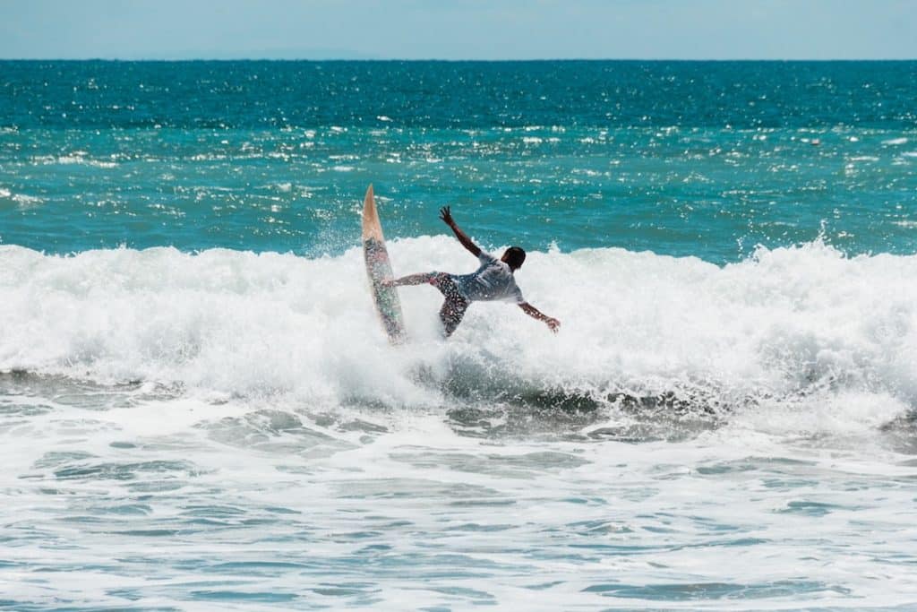 Young surfer doing tricks at Kuta beach