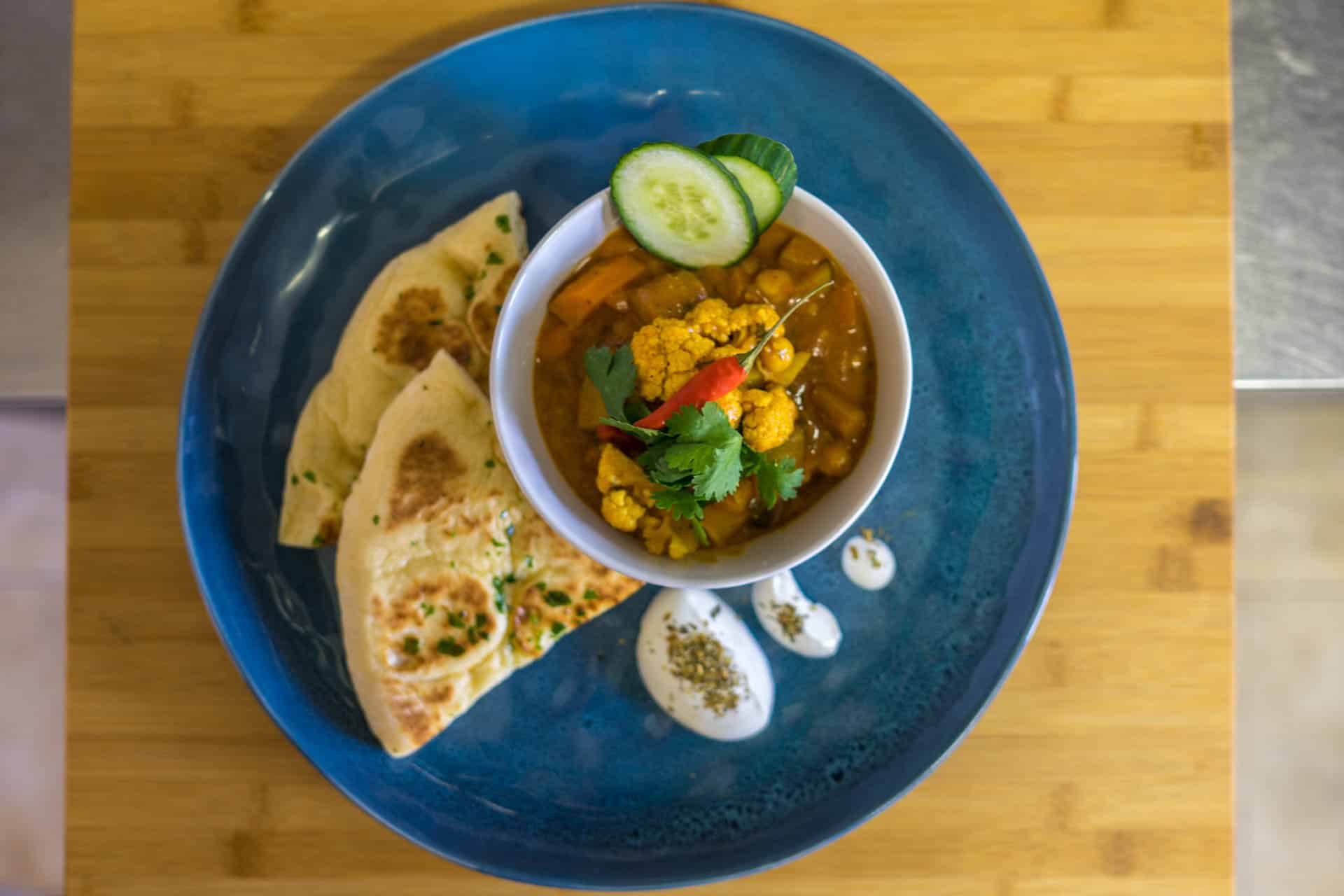 Veggie Curry served on a blue plate