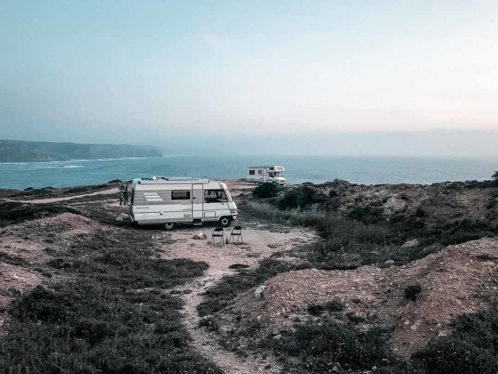 Two vans parked on the cliffs in Portugal