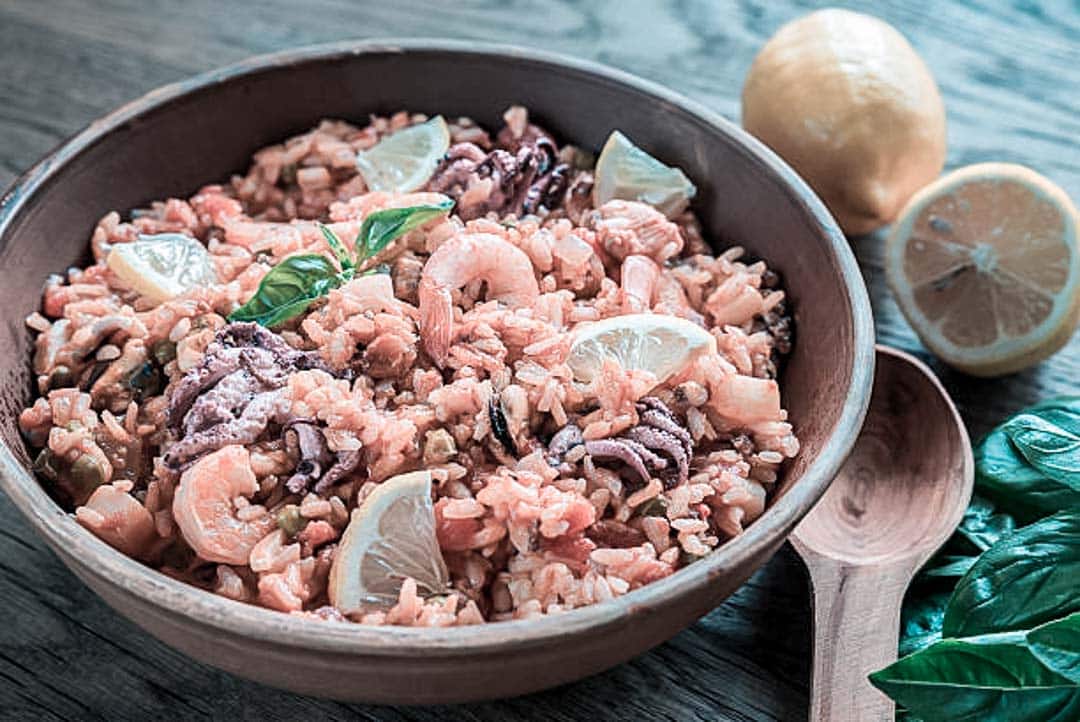 A bowl with rice, seafood and octopus