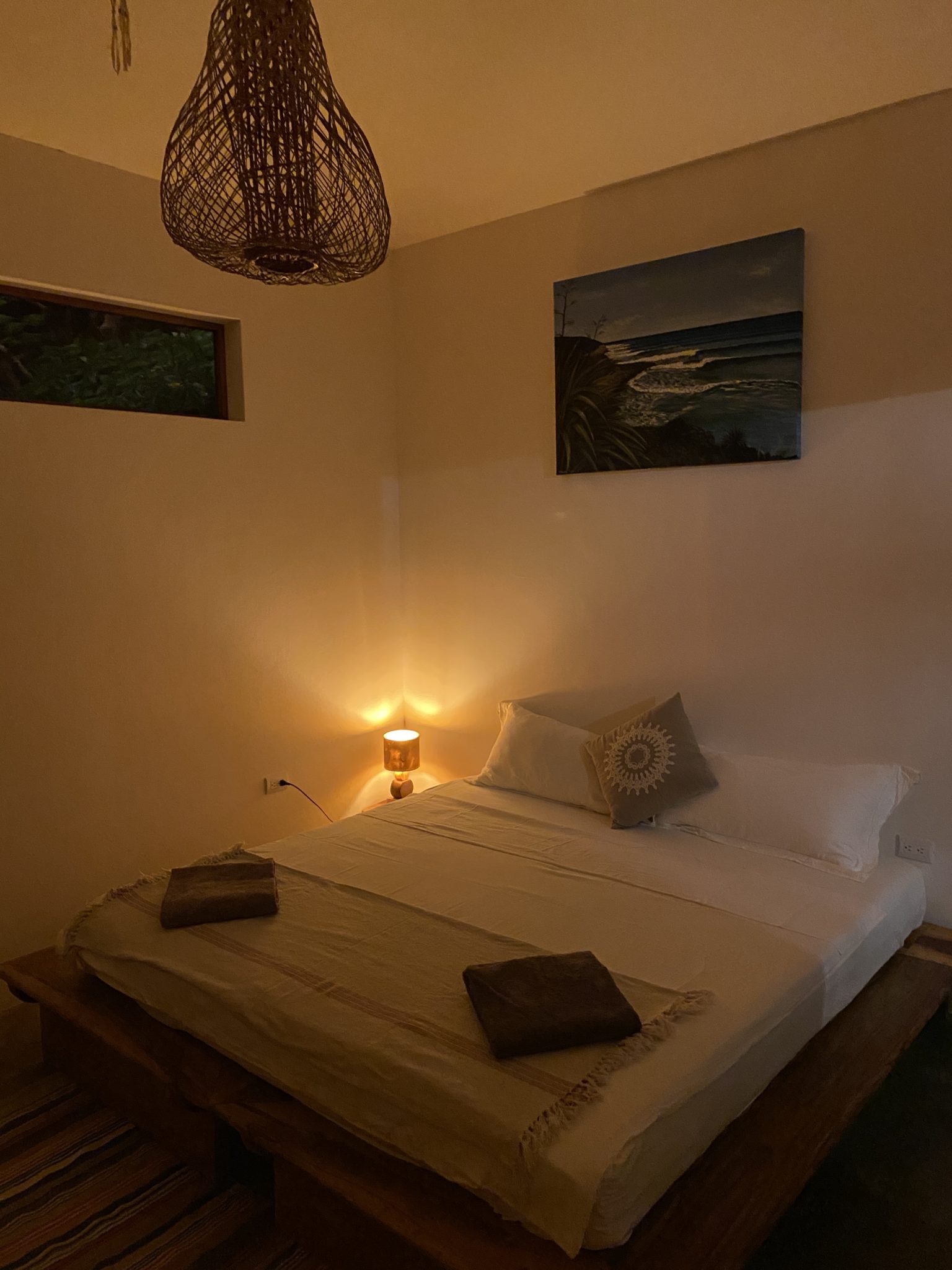 A bed in surf resort with light open at night