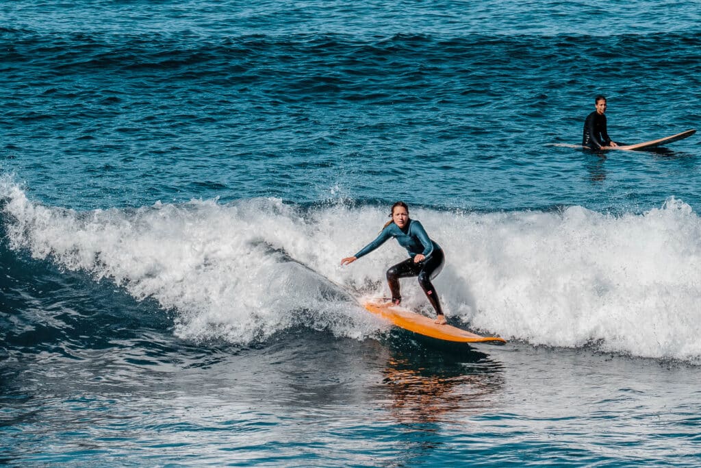 Surfers enjoying waves on rapture surf camp