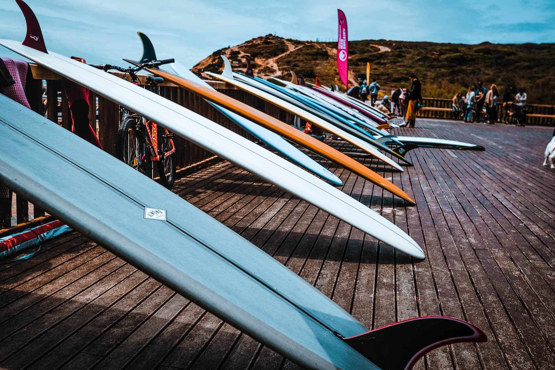Surfboards lined up on a deck