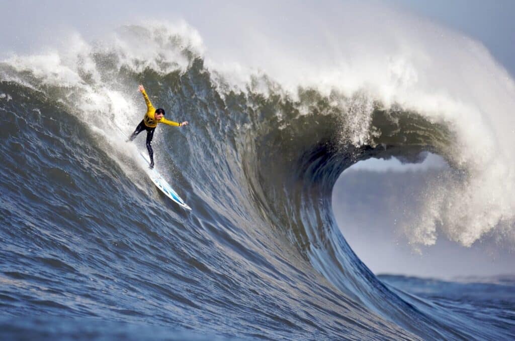 An image of a person surfing Mavericks, one of the highest waves in Northern California